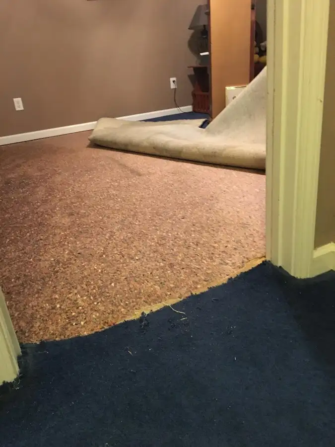Carpet pad removal revealing water damage during Water Mitigation Services in Stephenville