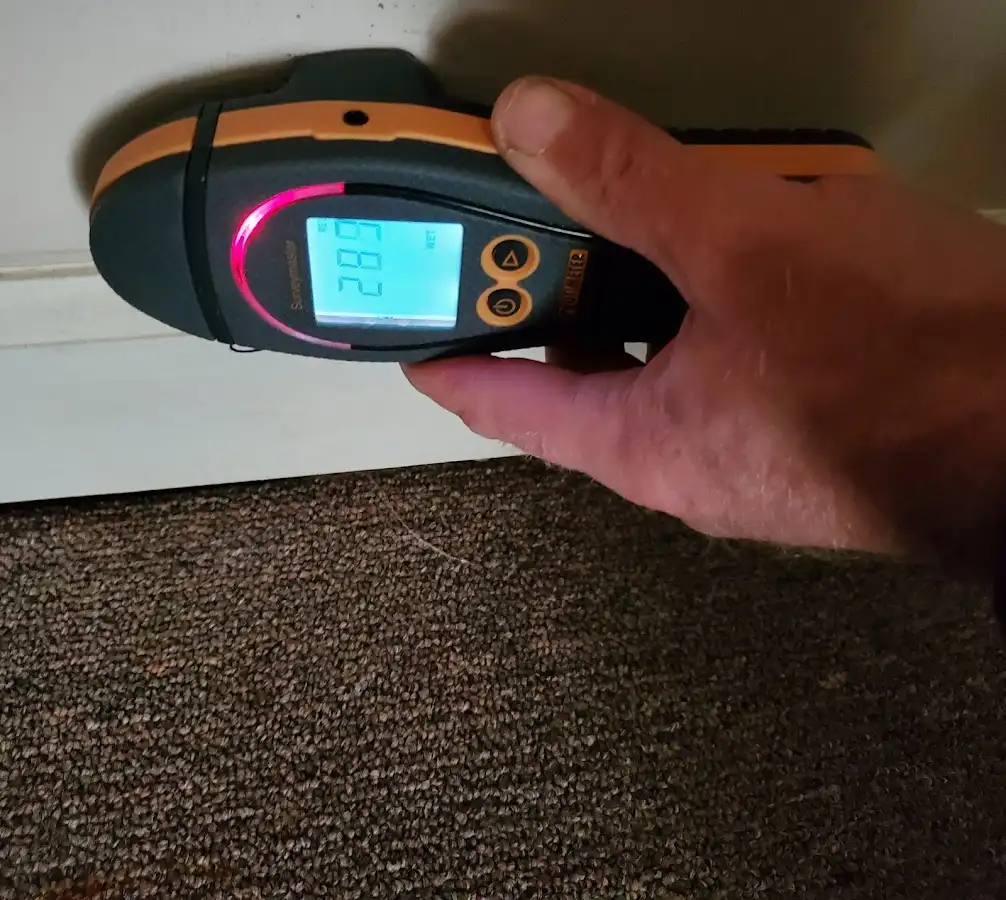 Moisture detection at baseboard during Storm Damage Restoration in Stephenville